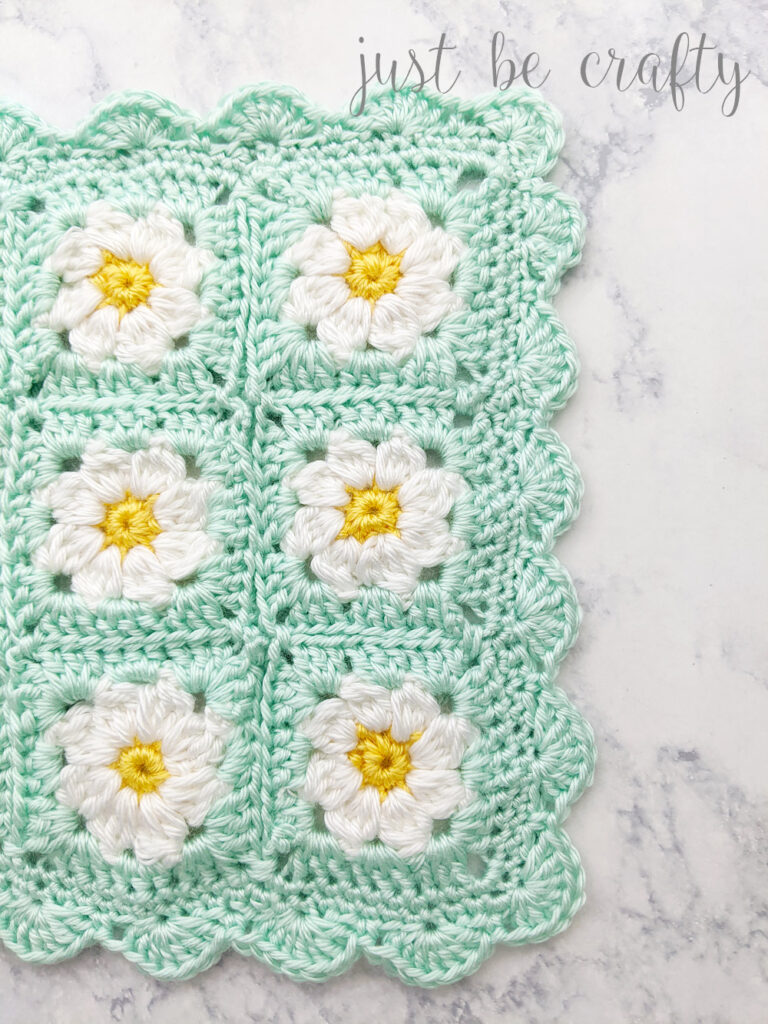 image of joined dainty daisy granny squares with a scalloped border