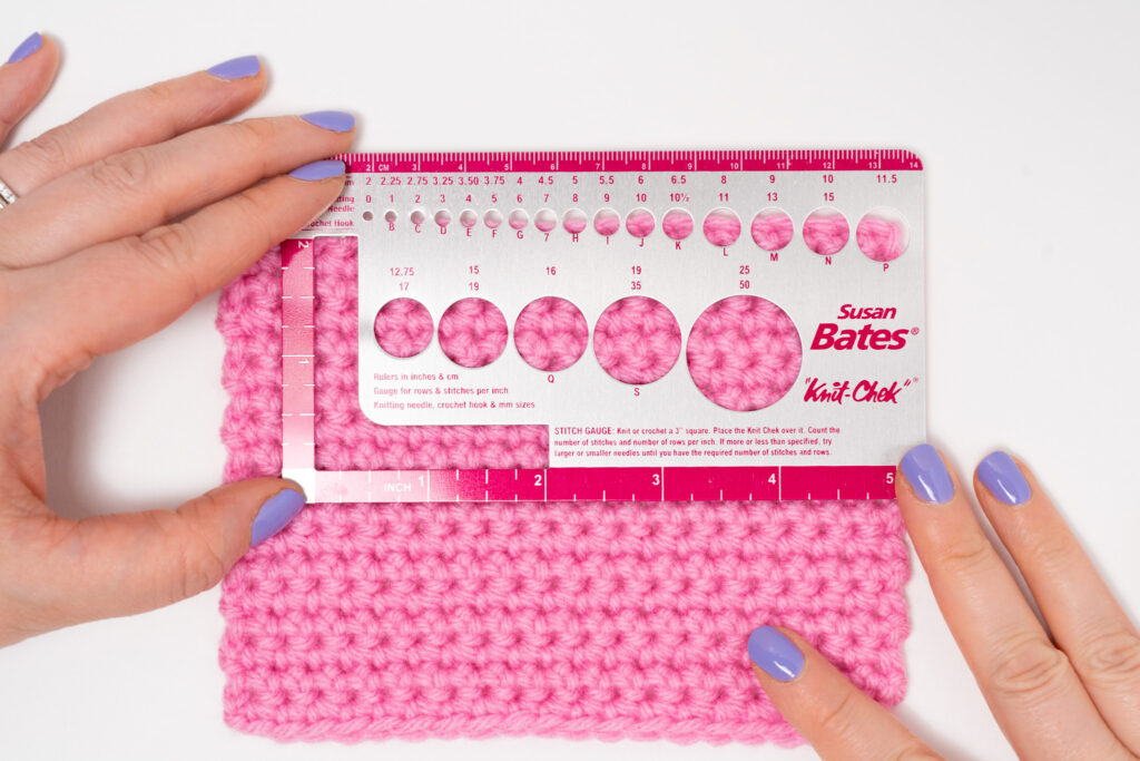 woman measuring gauge of a crocheted swatch with a susan bates knit chek