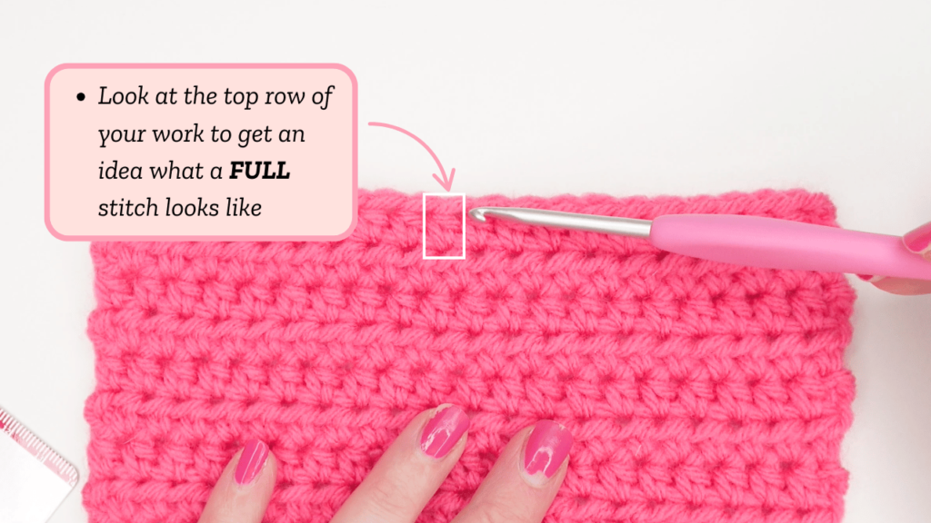 Top row of pink crochet swatch with a full stitch outlined in white