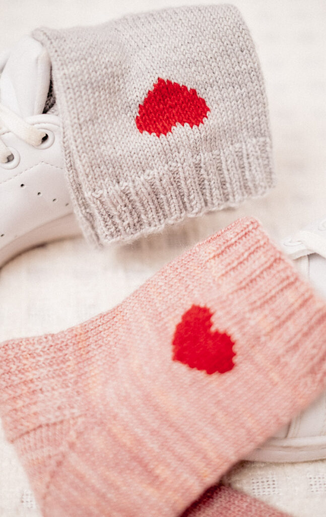 Cute knitted heart socks showcased with white sneakers