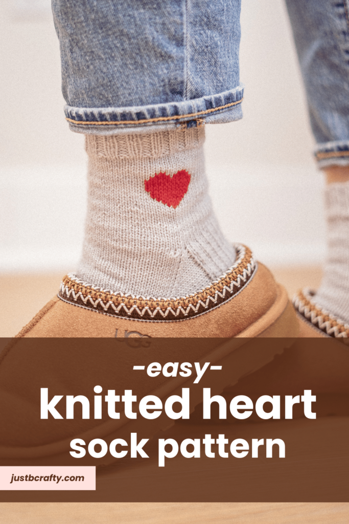 woman wearing grey handmade knitted socks with a heart detail.