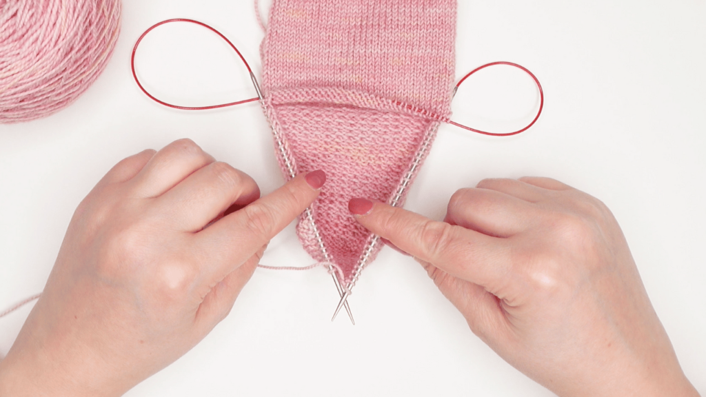 knitted socks in progress using the magic loop knitting method