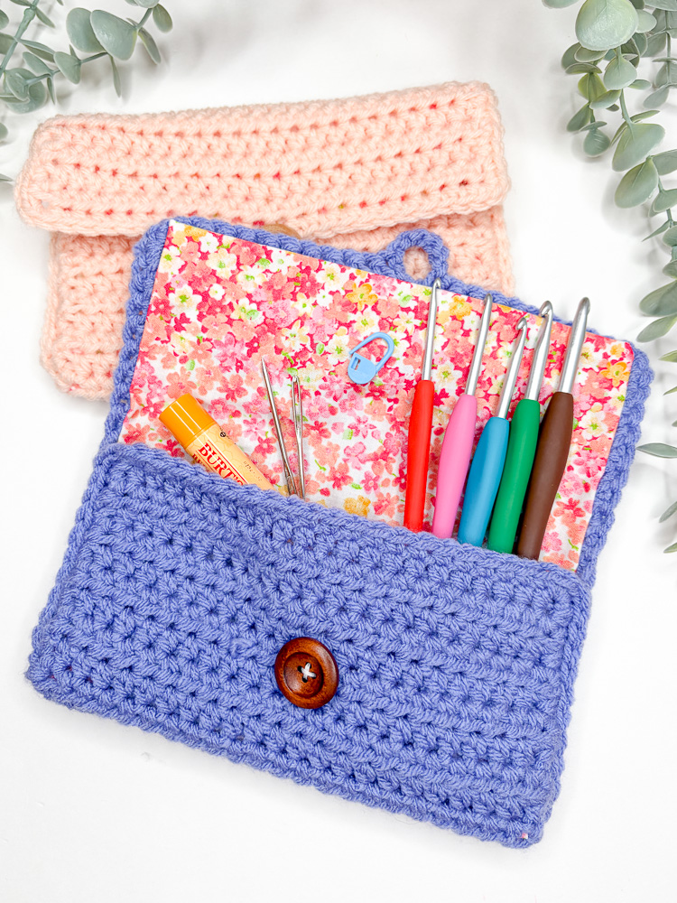 crochet hooks and notions arranged in a finished crochet fabric lined pouch
