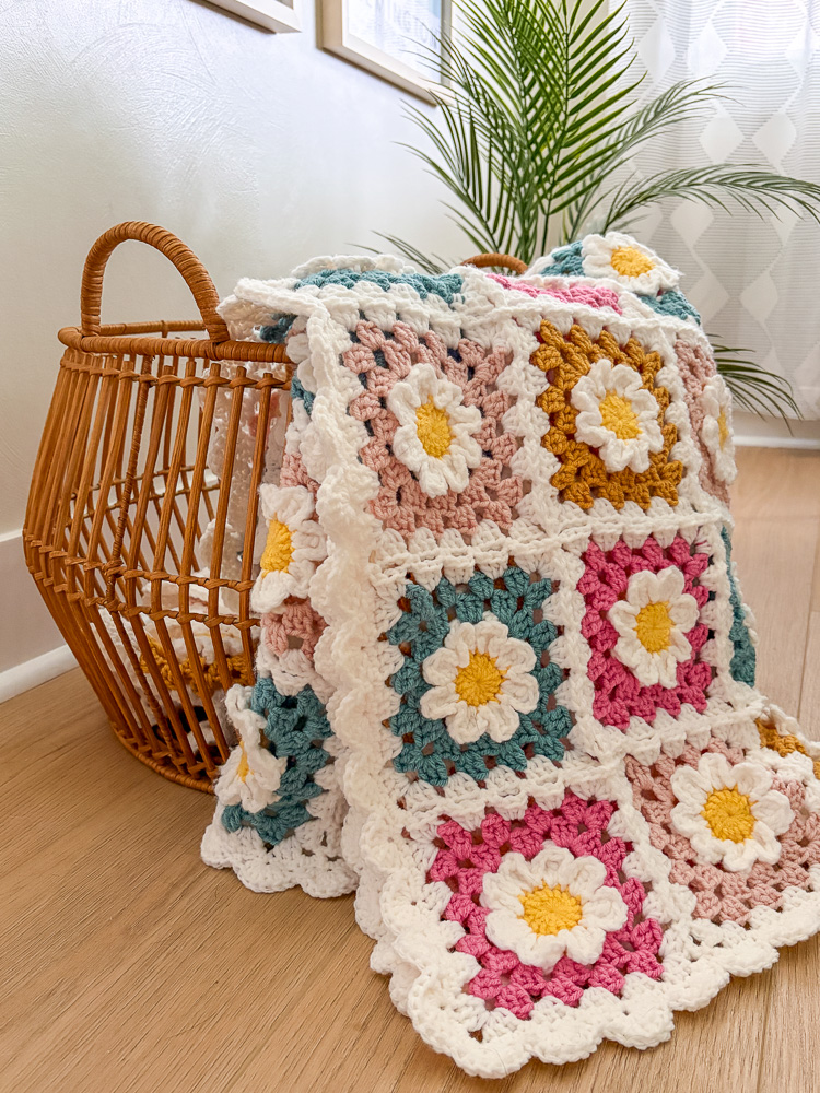3d flower granny square blanket spilling out of a basket