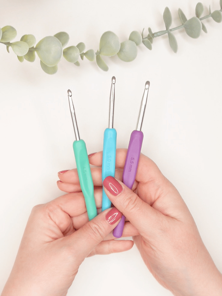 three metal crochet hooks