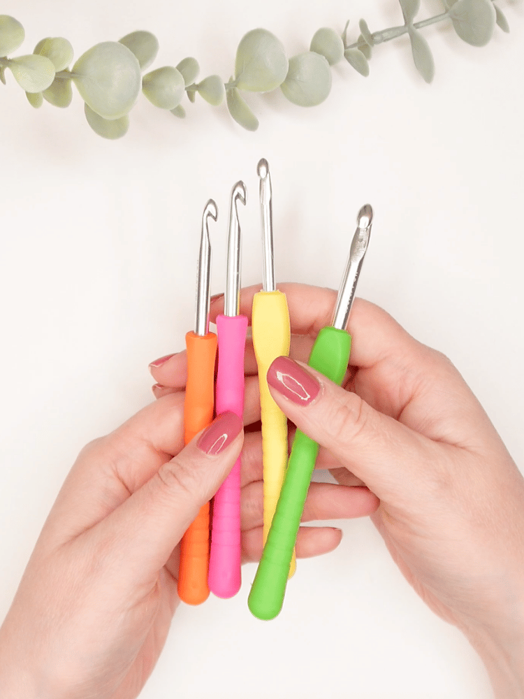 hands holding ergonomic crochet hook set