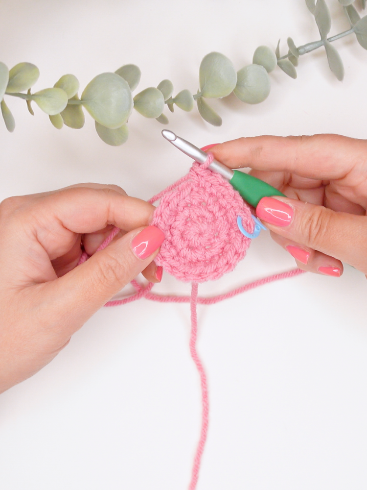 woman crocheting a half double crochet flat circle